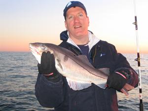 Todd McMahon displays one of the large haddock he landed aboard RELENTLESS